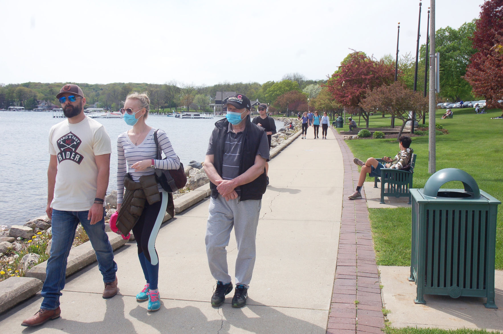 Visitors wear face masks in Library Park in Lake Geneva